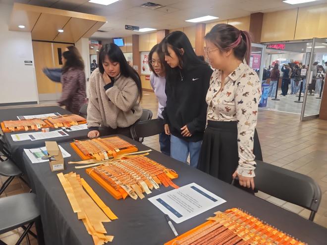 Early Chilldhood Education students visit a weaving activity at National Day for Truth and Reconciliation Education Stations at Langara College.