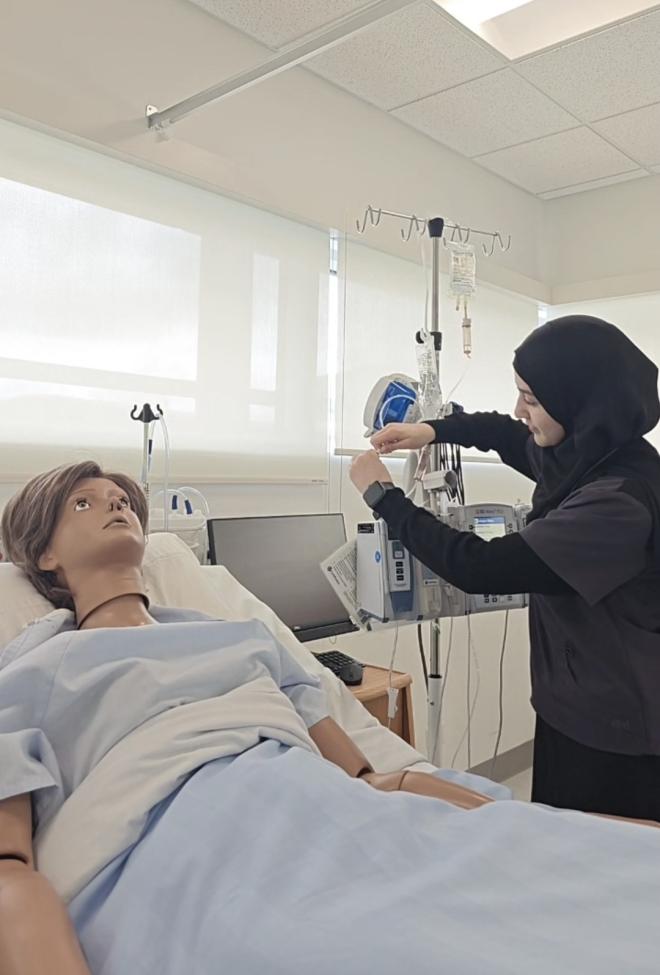 Student Layla Ayyash working in the nursing laboratory.