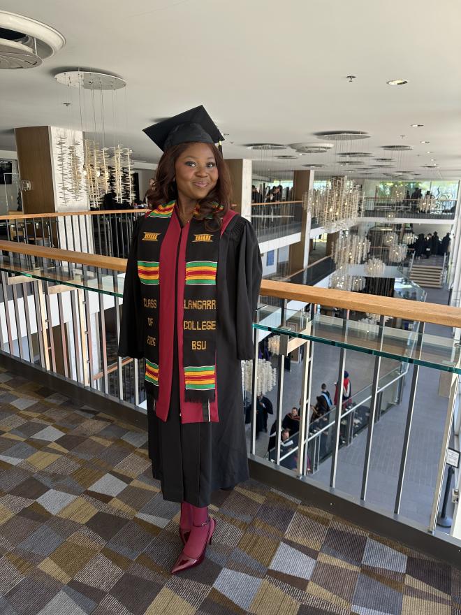 Graduate, Bolu Akinwale, proudly wearing her convocation regalia and Kente stole.