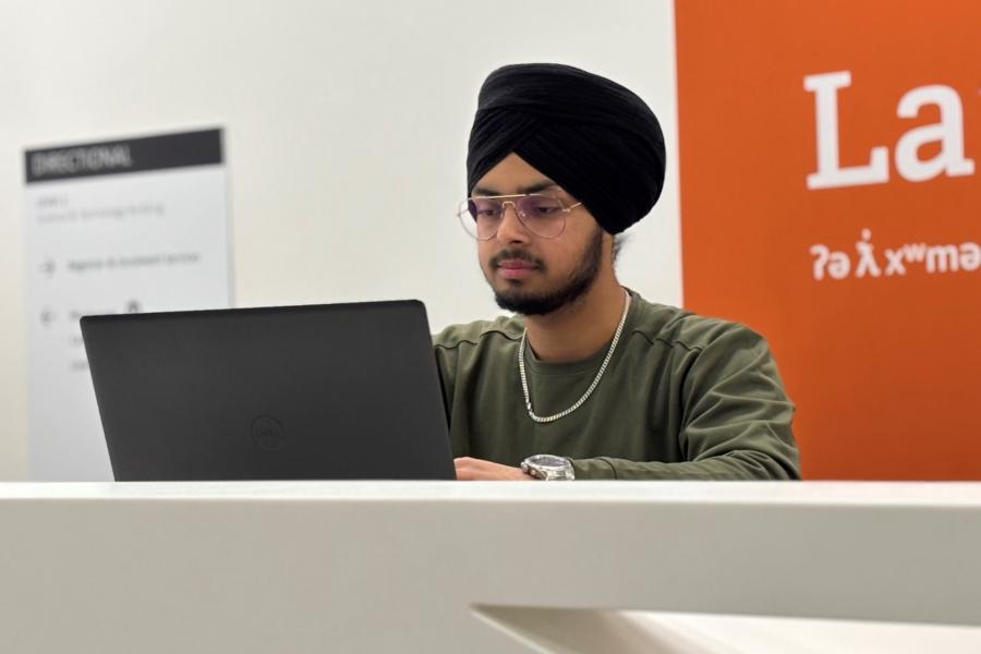 Student Onkar Bhullar works on a laptop.