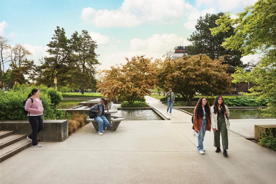 Students walking near the reflective pond at Langara College's campus located in the heart of Vancouver, British Columbia, Canada.