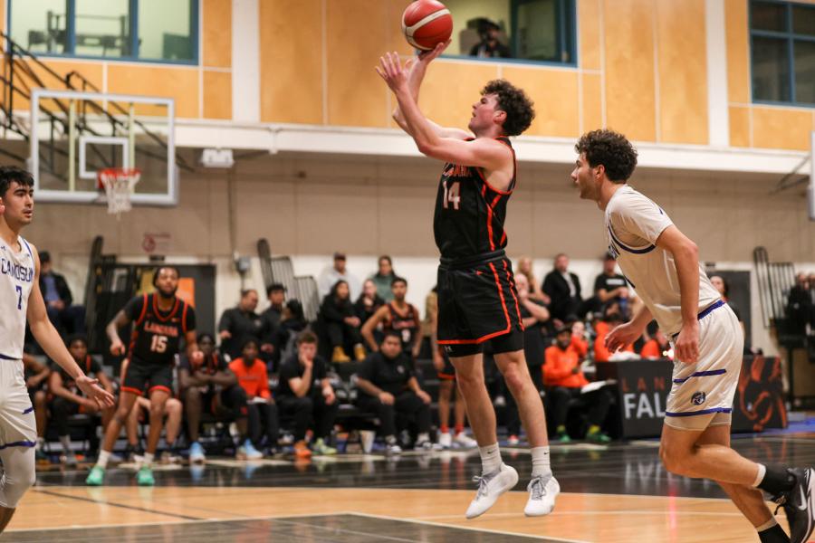 Falcons men's basketball player jumping