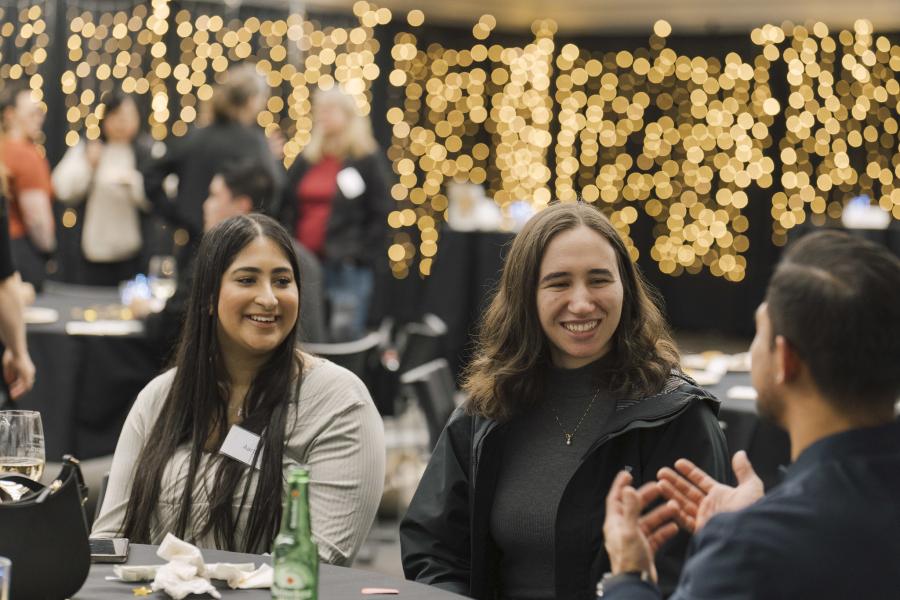 Three alumni seated at a table for the RMT 10-year Anniversary Celebration