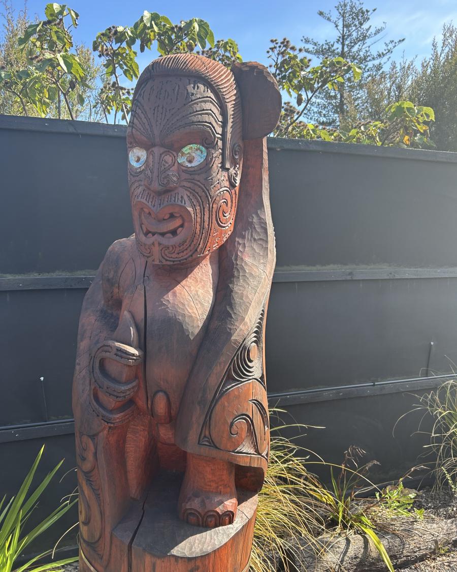 A carved Māori statue.