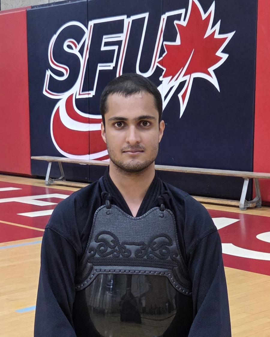 Criminology program alumnus Harmun Nagra pictured in the SFU gymnasium.