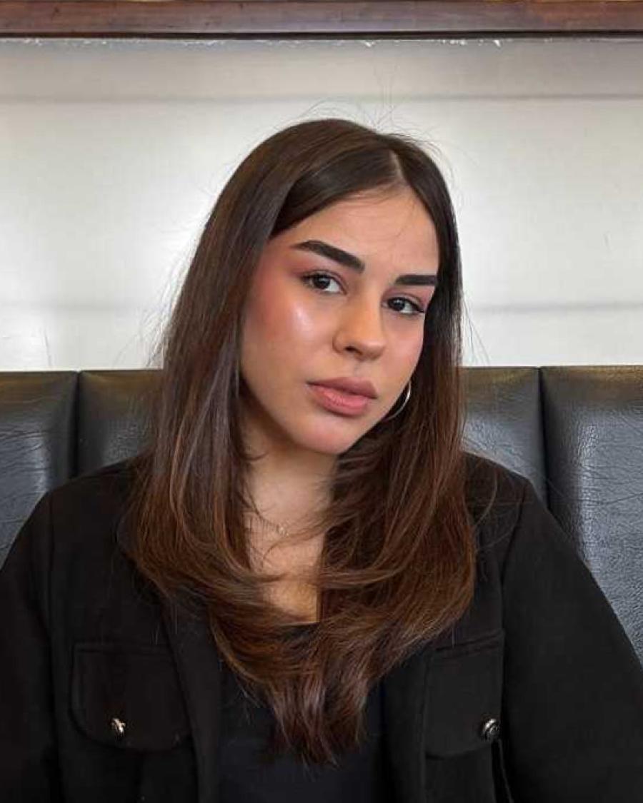 Female student portrait wearing black clothing, facing the camera with a neutral expression.